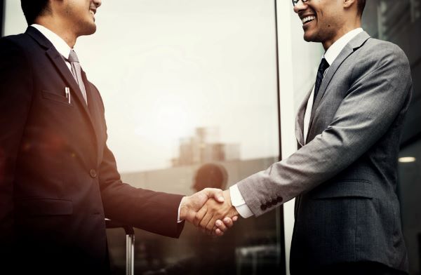 corporate businessmen shaking hands